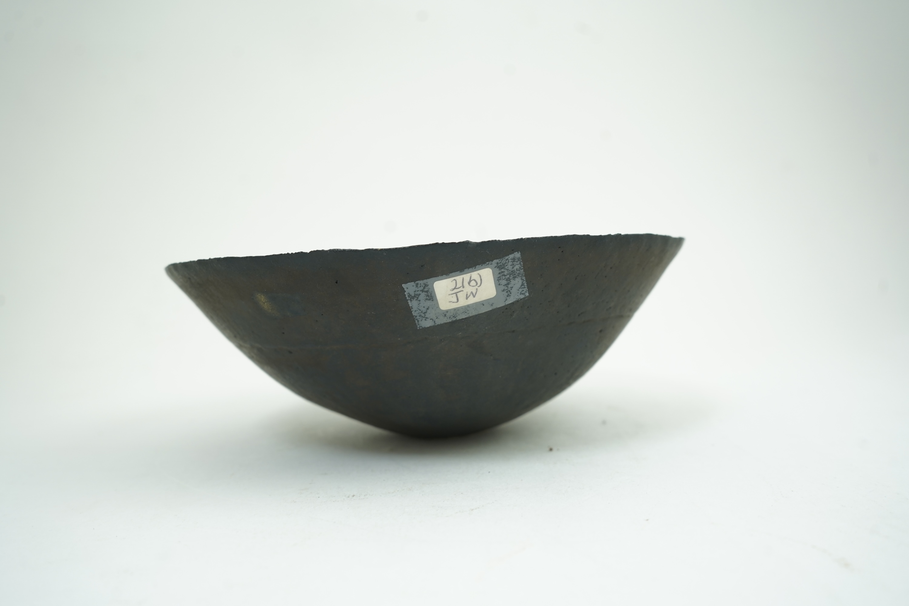 John Ward (1938-2023): A hand-built stoneware black glazed bowl with irregular rim